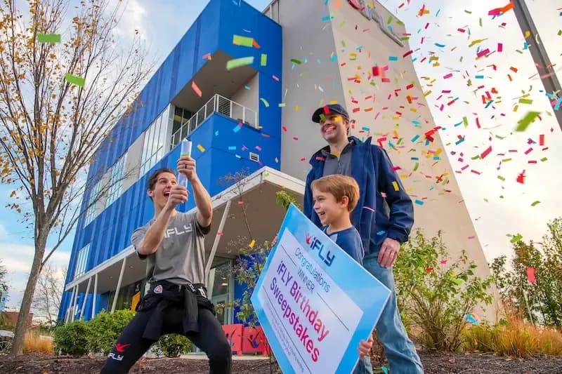 A father celebrates winning the birthday sweepstakes with shooting confetti